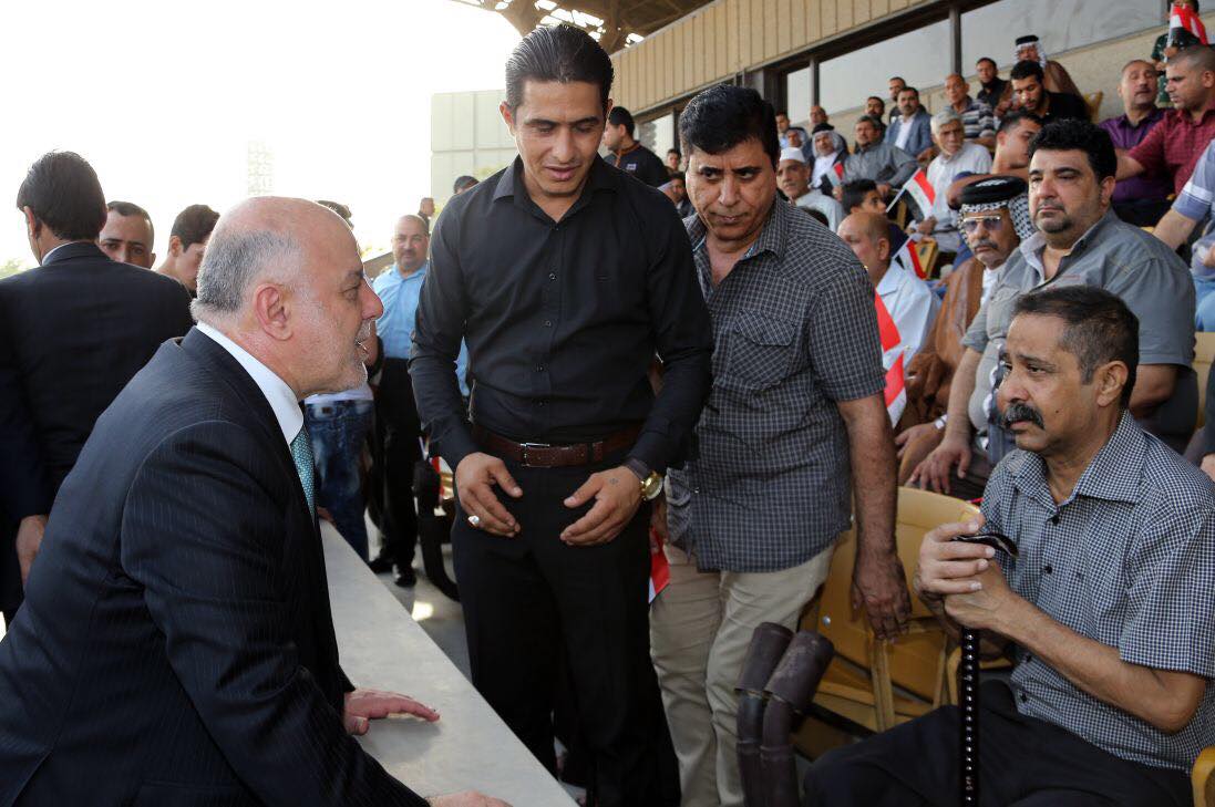 Iraqi Prime Minister Haider al-Abadi with the families of the fallen Iraqi soldiers during the military parade in Baghdad, July 15, 2017. (Photo: Iraqi Prime Minister’s Press Office)